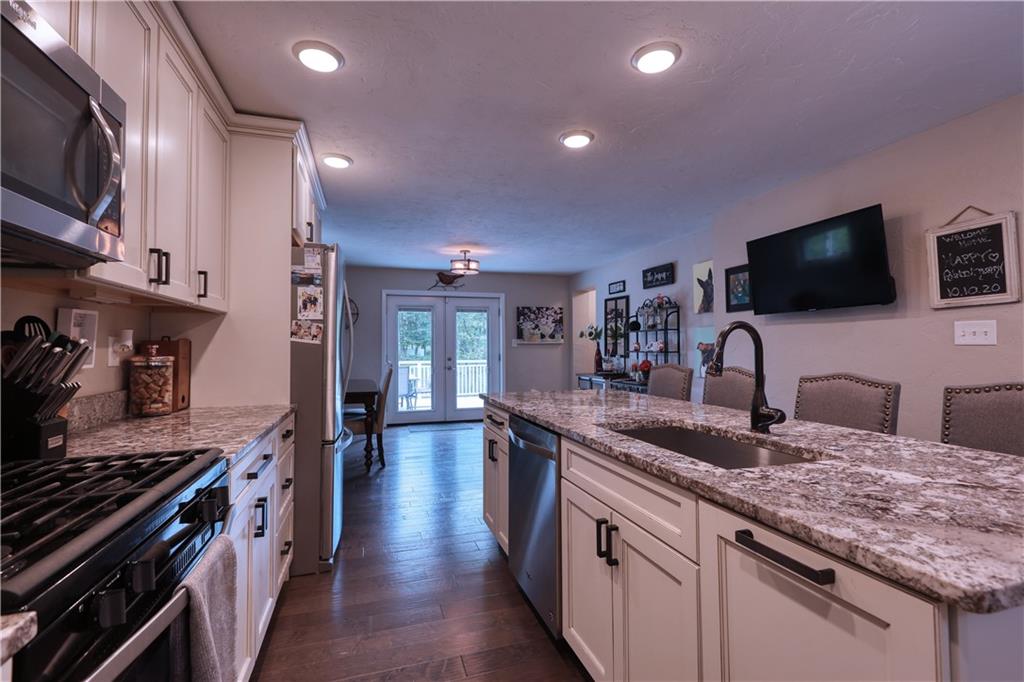 1243 Silver Lane McKees Rocks, PA 15136 - Photo 5 of 21 a kitchen with granite countertop a sink and stainless steel appliances