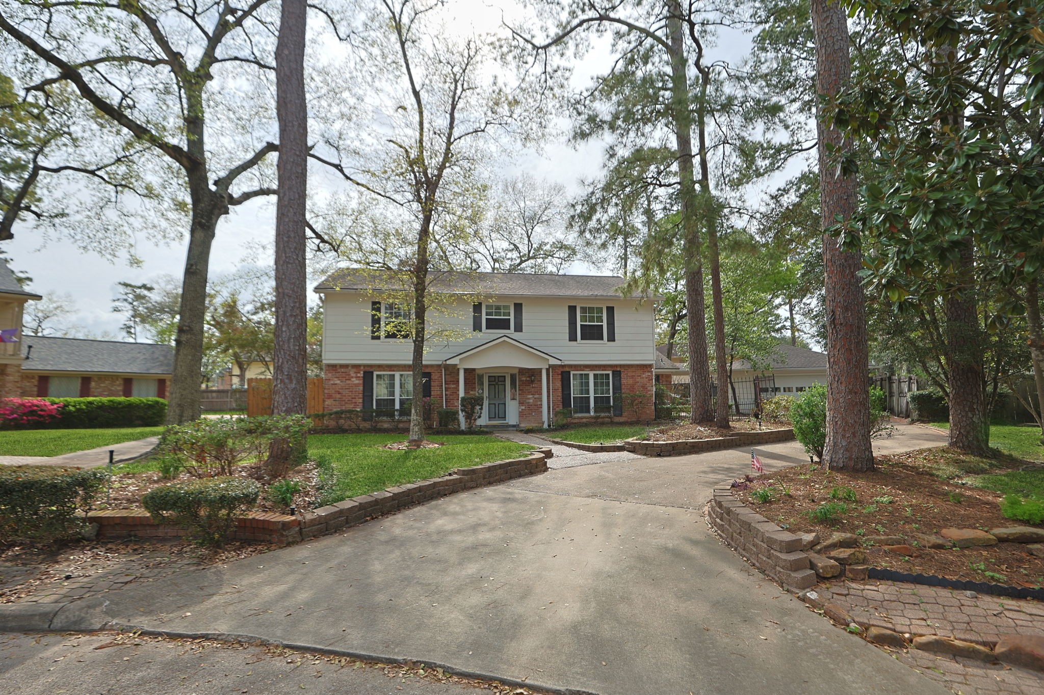 For this stately home, the uniqueness starts at the curb, with the lovely, winding drivewy and custom flowerbeds.