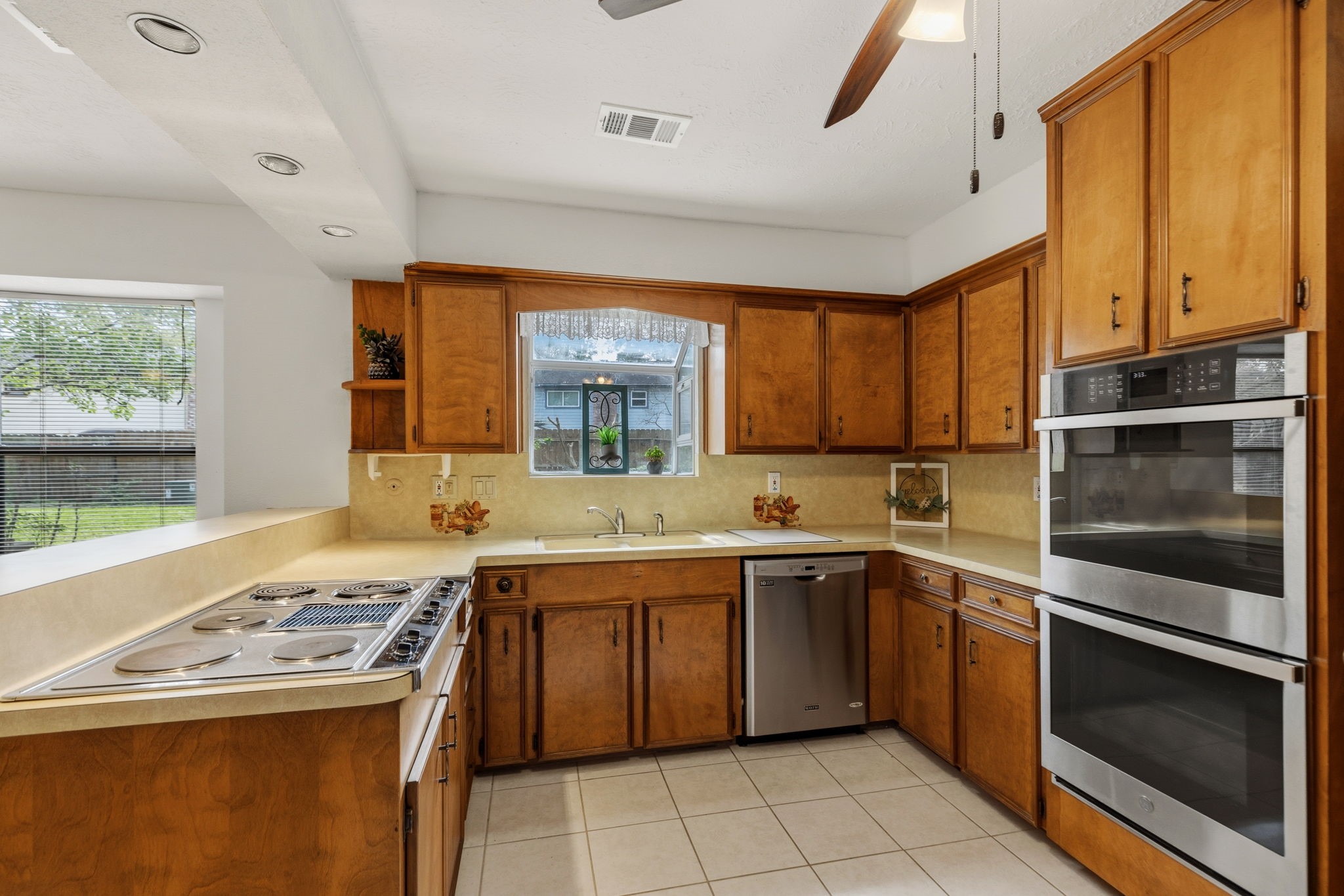 17507 Oxhill Court Spring, TX 77388 - Photo 15 of 44 The kitchen has a lovely view into the backyard, and a cute little corner display shelf!
