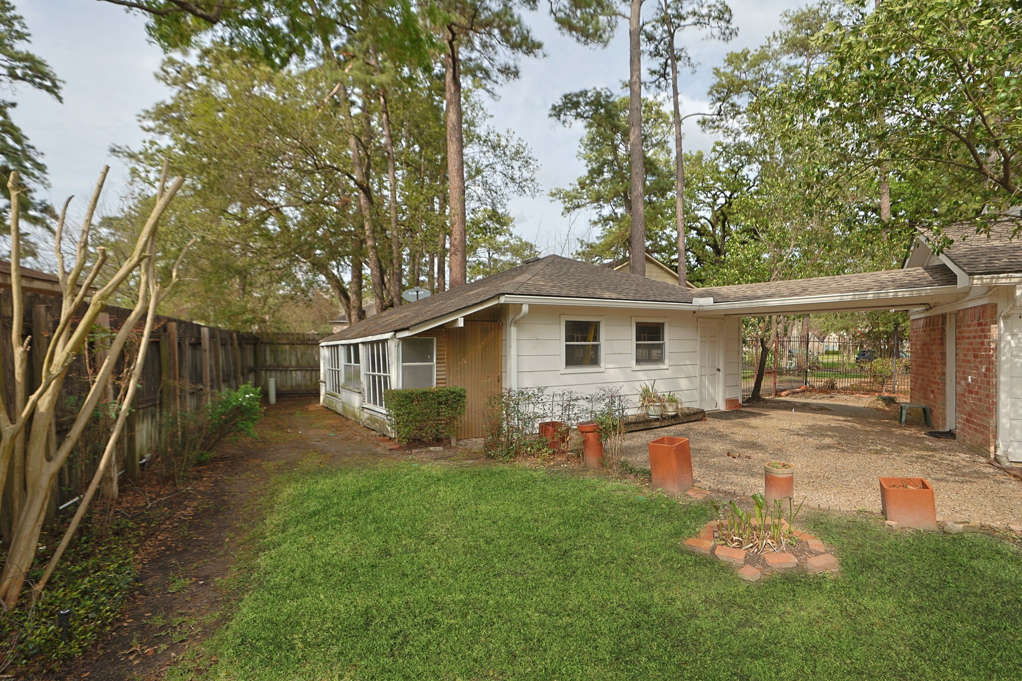 17507 Oxhill Court Spring, TX 77388 - Photo 33 of 44 This view shows part of the extended patio, the covered walkway from the garage to the untility room in the home, and the greenhouse behind the garage.