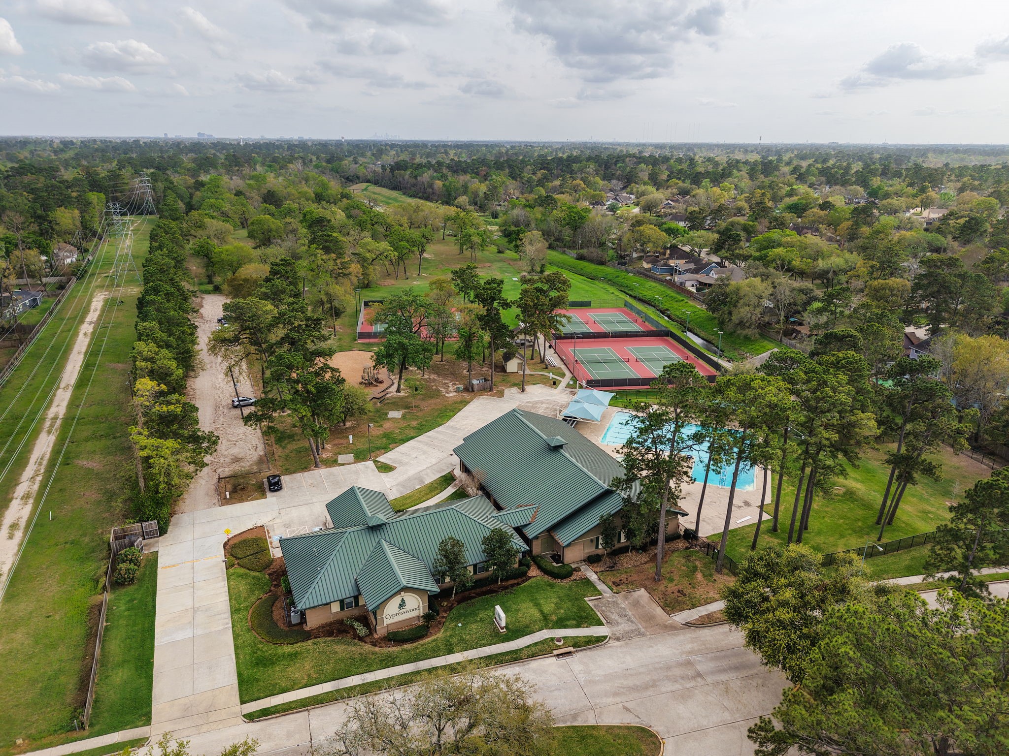 17507 Oxhill Court Spring, TX 77388 - Photo 34 of 44 Cypresswood has two different clubhouse areas. This is one of the clubhouses, a pool, and some tennis courts, surrounded by beautiful greenspace!