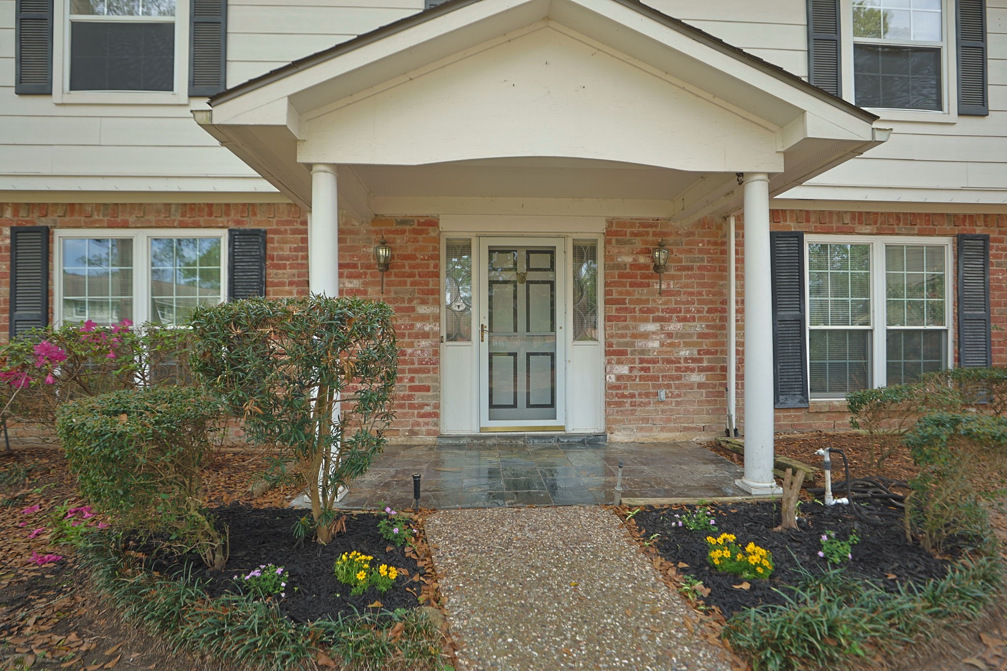 17507 Oxhill Court Spring, TX 77388 - Photo 4 of 44 The sidewalk leads trhough anothe lovely flower bed and adorable porch to the grand entryway.