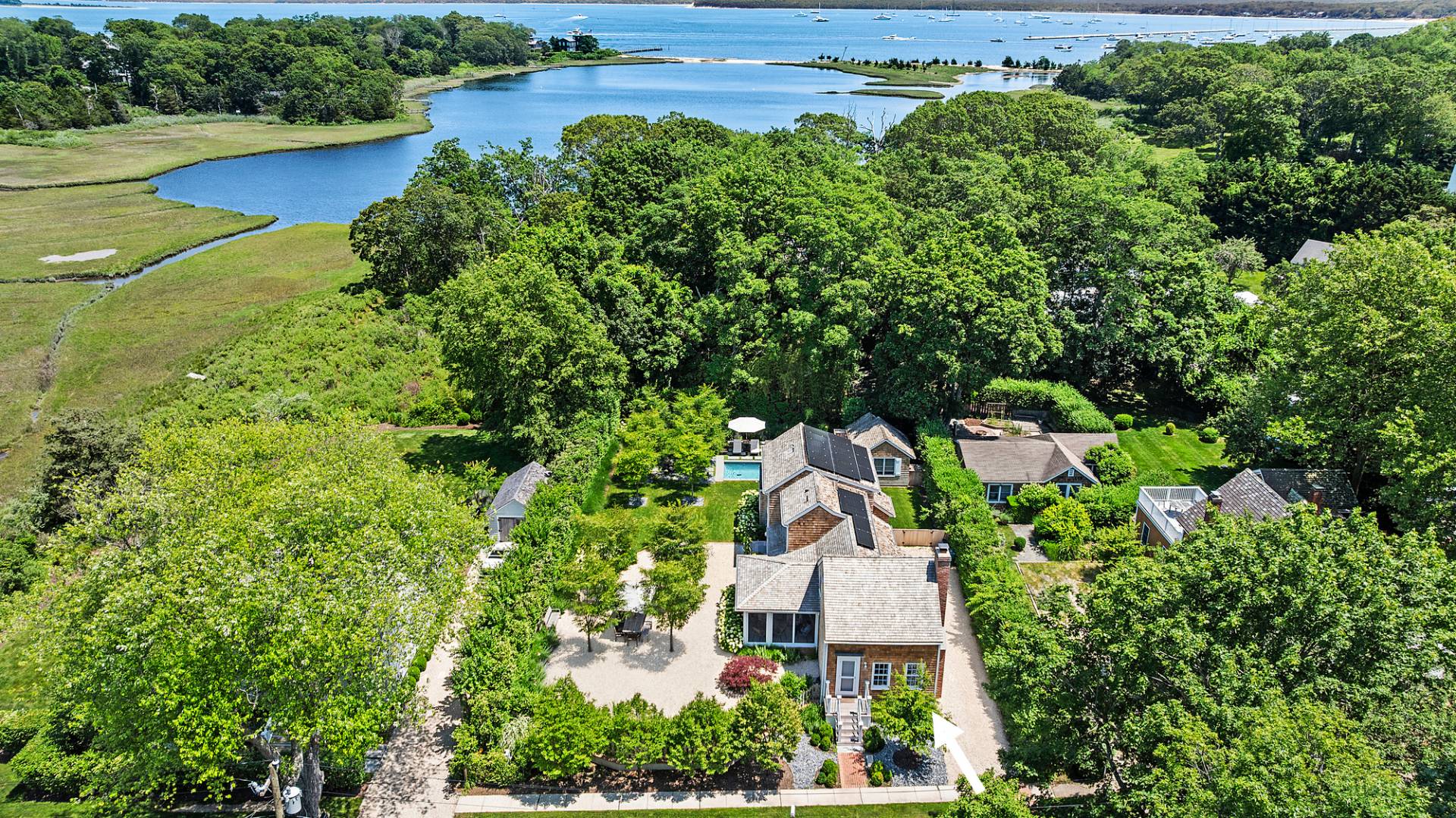 an aerial view of a house with garden space and outdoor seating