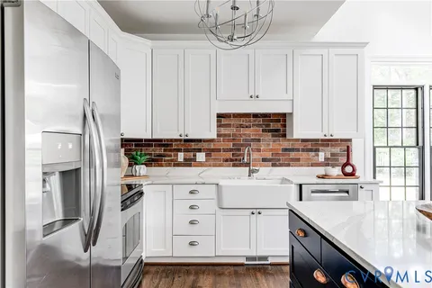 a kitchen with cabinets appliances a sink and a counter top space