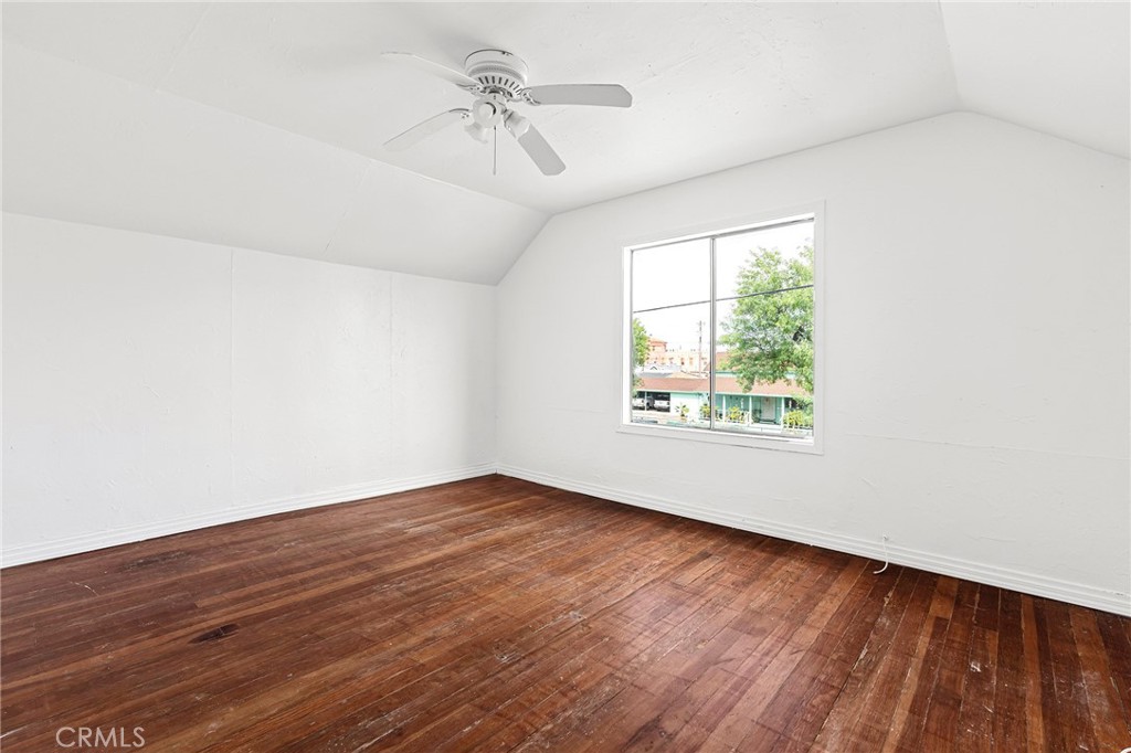 818 6th Street Corning, CA 96021 - Photo 20 of 32 an empty room with wooden floor fan and windows