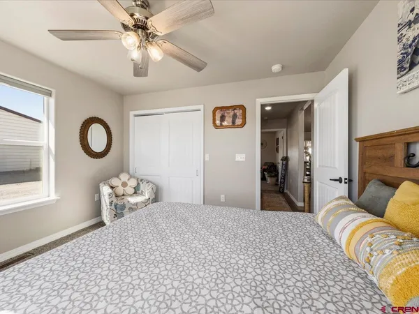 a bedroom with bed and a chandelier