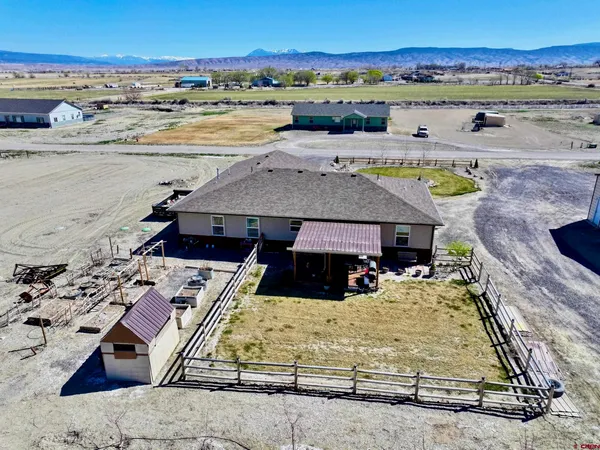 an aerial view of a house with ocean view