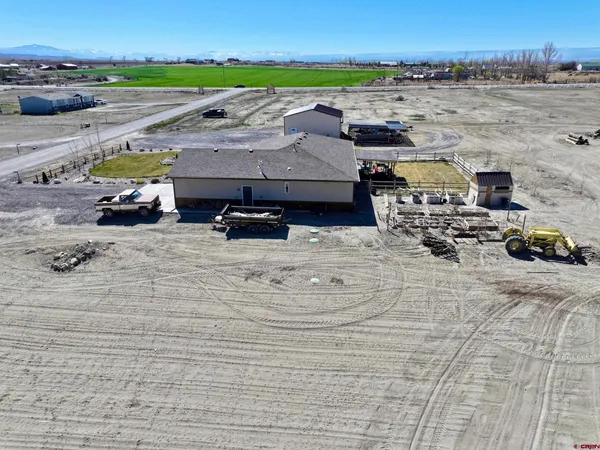 an aerial view of a house with a yard