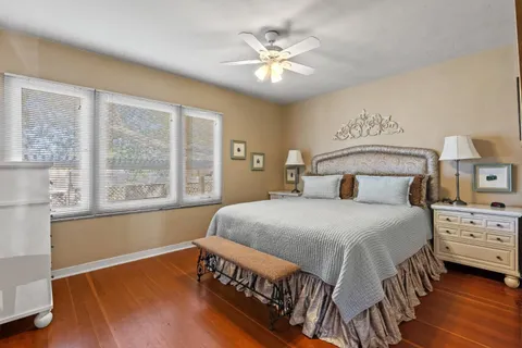 a bedroom with a bed and a large window