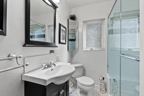 a bathroom with a toilet sink and mirror