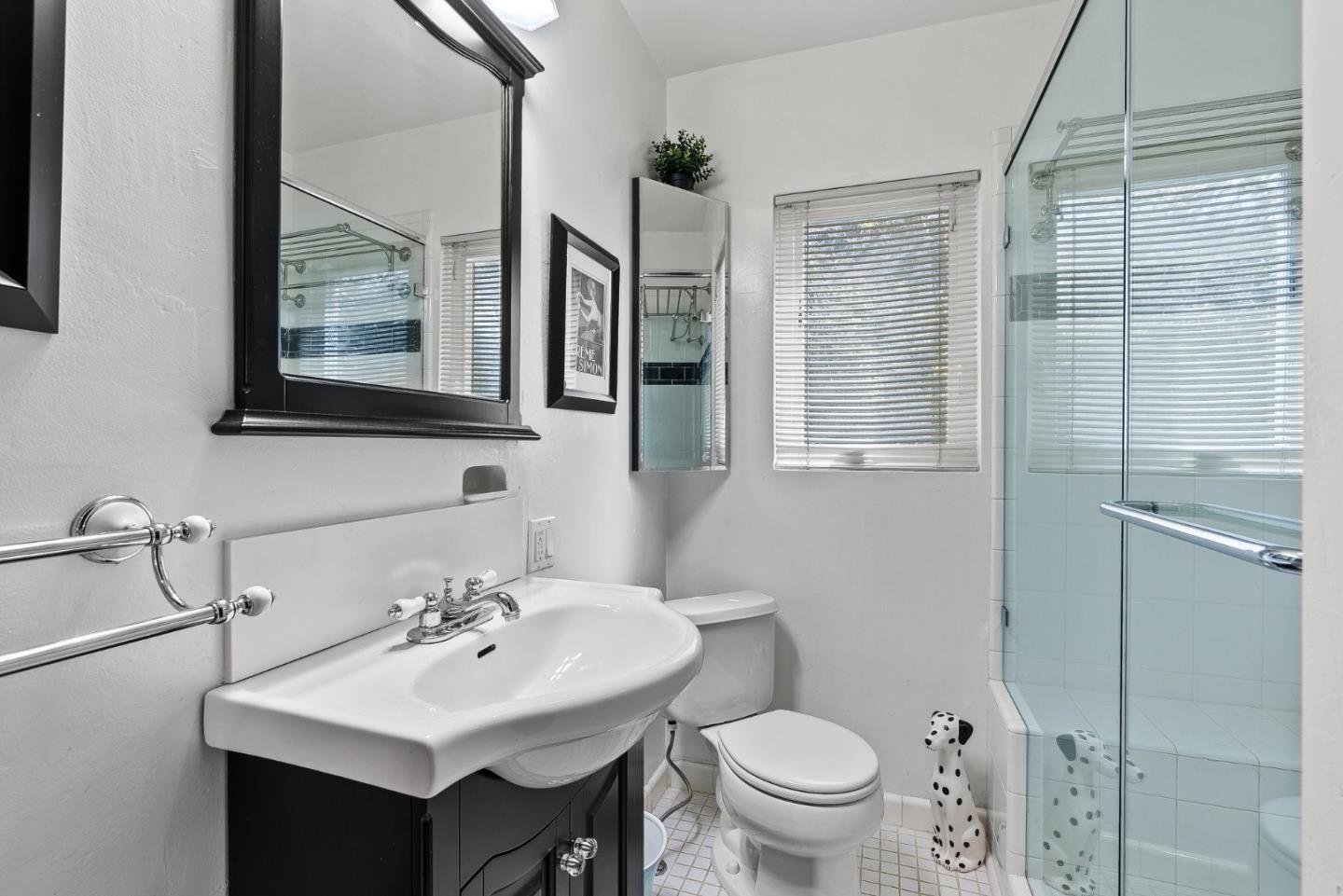 925 Cass Street Monterey, CA 93940 - Photo 13 of 27 a bathroom with a toilet sink and mirror