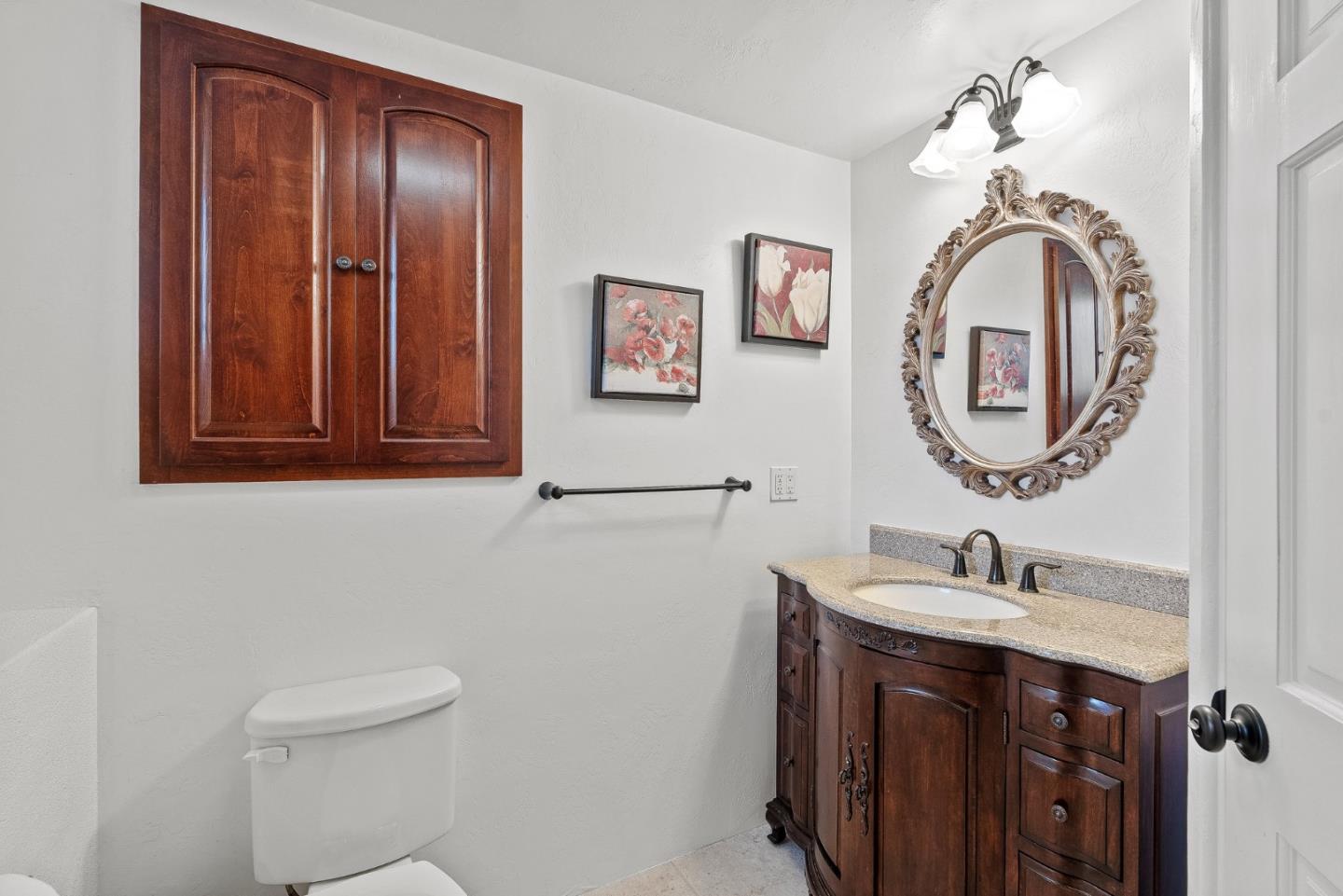 925 Cass Street Monterey, CA 93940 - Photo 21 of 27 a bathroom with a sink and a mirror