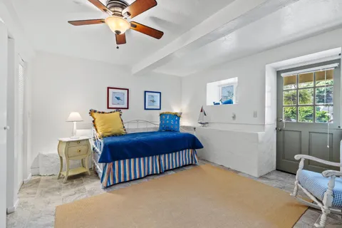 a bedroom with a bed dresser and a window