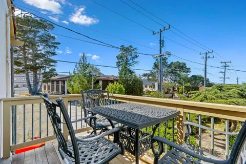 a view of balcony with furniture and potted plants