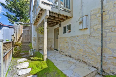 a aerial view of a house with a big yard and potted plants