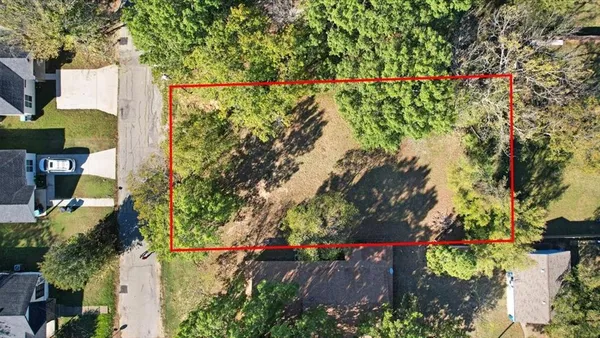 an aerial view of a house with a yard and garden