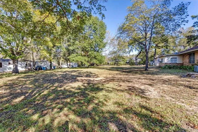 a backyard of a house with large trees