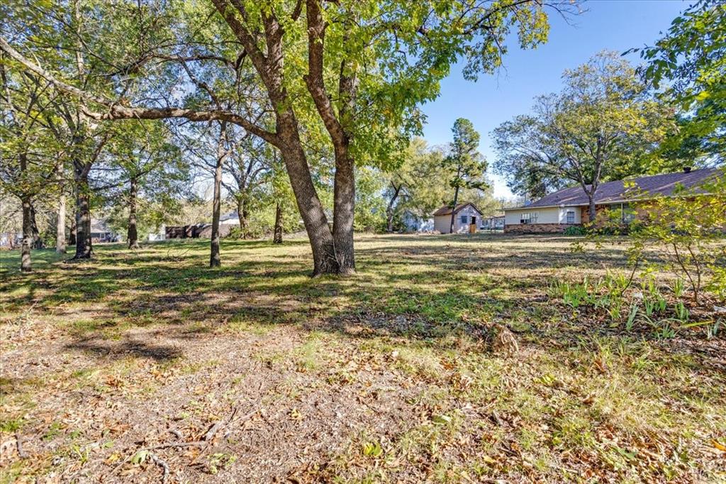 603 West Star Street Denison, TX 75020 - Photo 4 of 8 a view of a yard with a trees