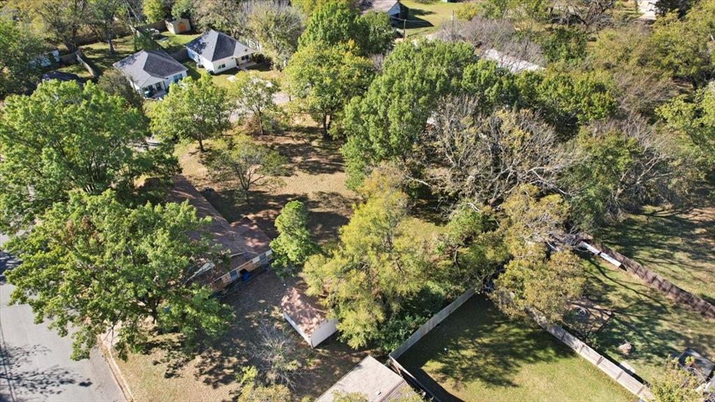 603 West Star Street Denison, TX 75020 - Photo 8 of 8 a backyard of a house with lots of trees