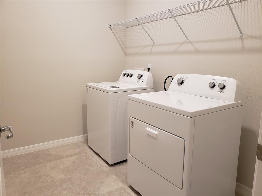 17244 Cagan Crossings Boulevard Clermont, FL 34714 - Photo 13 of 14 a utility room with dryer and washer
