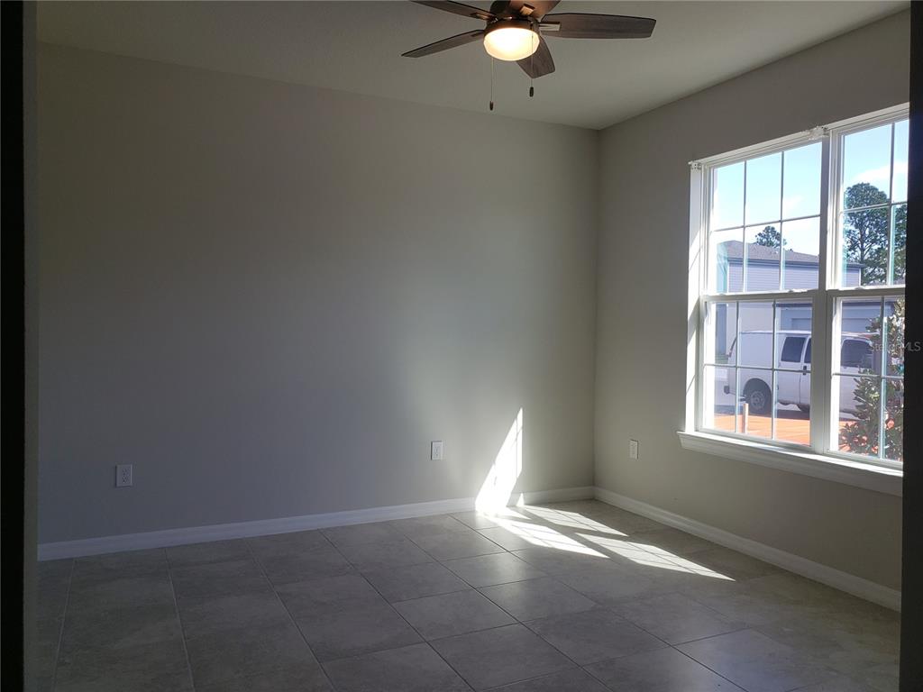 17244 Cagan Crossings Boulevard Clermont, FL 34714 - Photo 8 of 14 an empty room with windows and fan