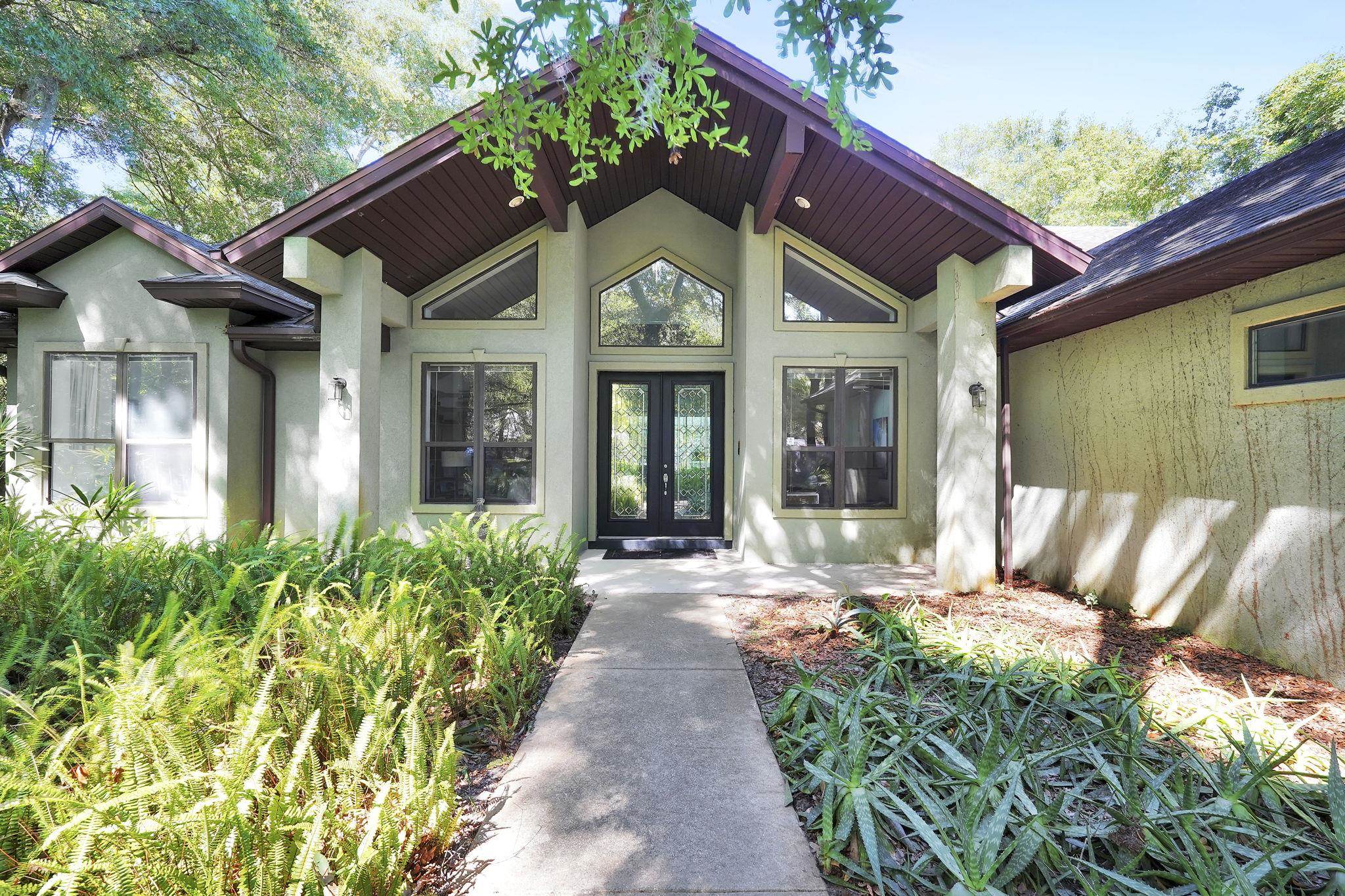 a front view of a house with garden