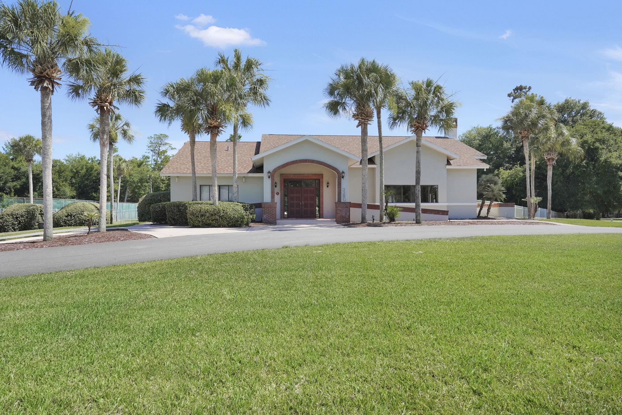3372 Kings Road South St. Augustine, FL 32086 - Photo 28 of 48 a view of a house with a yard and palm trees