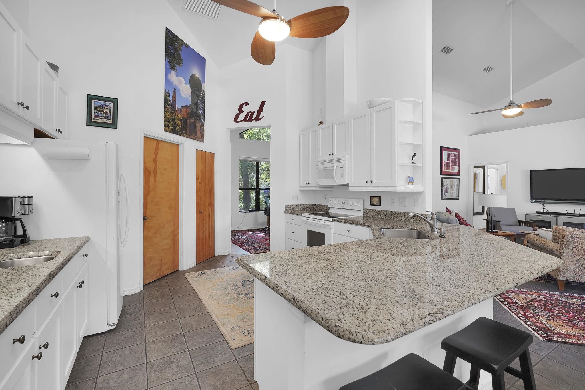 3372 Kings Road South St. Augustine, FL 32086 - Photo 10 of 48 a kitchen with stainless steel appliances granite countertop a sink refrigerator and microwave