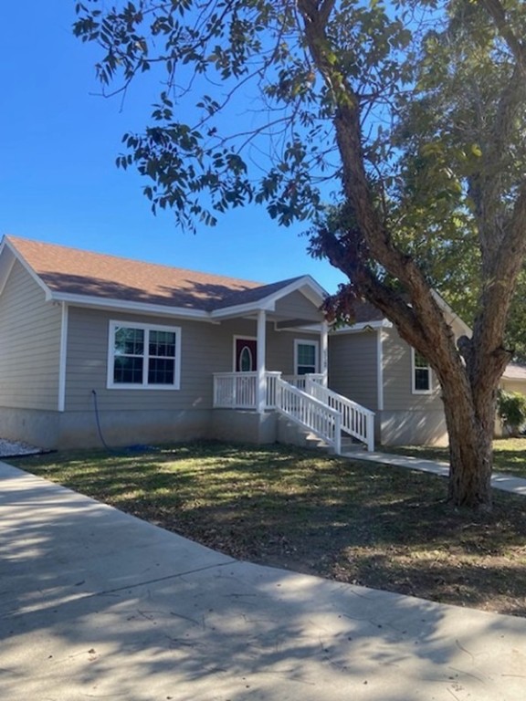 a view of a house with a large tree