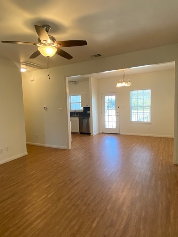 112 Palmo Drive Luling, TX 78648 - Photo 12 of 24 a view of an empty room with a window and wooden floor