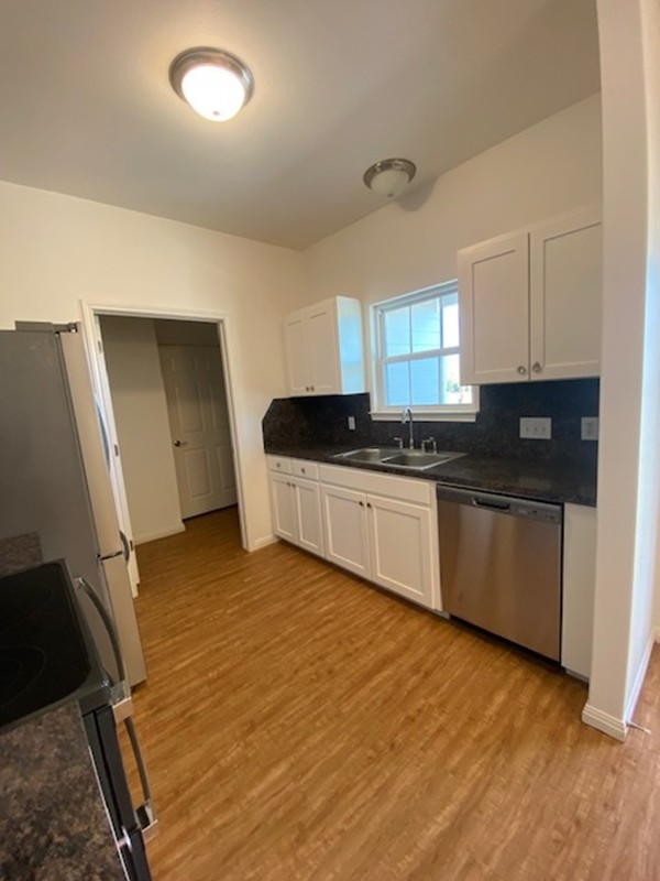 112 Palmo Drive Luling, TX 78648 - Photo 18 of 24 a kitchen with granite countertop a sink and cabinets