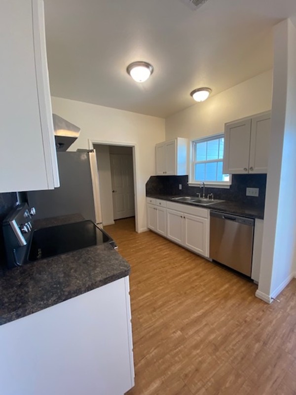 112 Palmo Drive Luling, TX 78648 - Photo 20 of 24 a kitchen with stainless steel appliances granite countertop a sink stove and refrigerator
