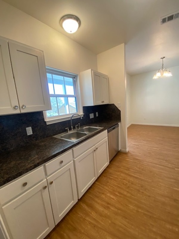 112 Palmo Drive Luling, TX 78648 - Photo 22 of 24 a kitchen with granite countertop a sink and a stove