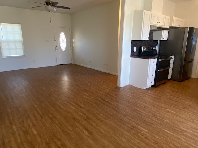 112 Palmo Drive Luling, TX 78648 - Photo 24 of 24 a view of a kitchen with wooden floor and a ceiling fan