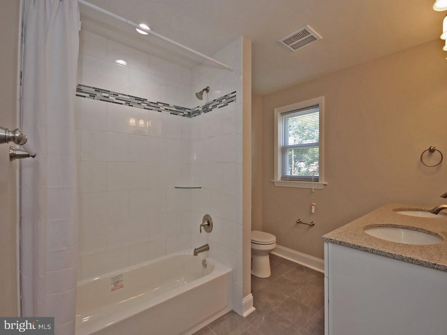 449 Pinecrest Road Springfield, PA 19064 - Photo 13 of 25 a bathroom with a granite countertop sink toilet and shower