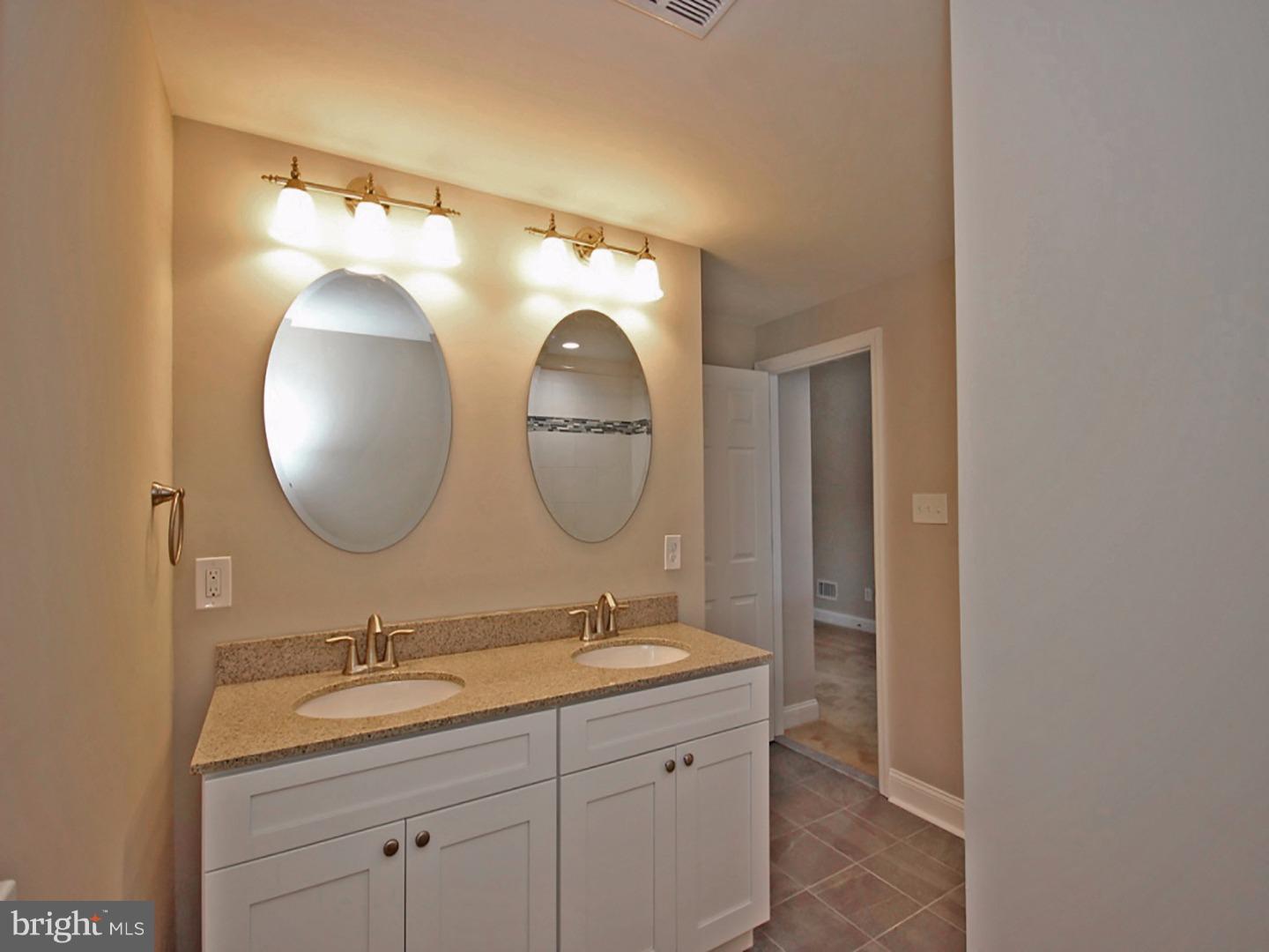 449 Pinecrest Road Springfield, PA 19064 - Photo 14 of 25 a bathroom with a double vanity sink and a mirror