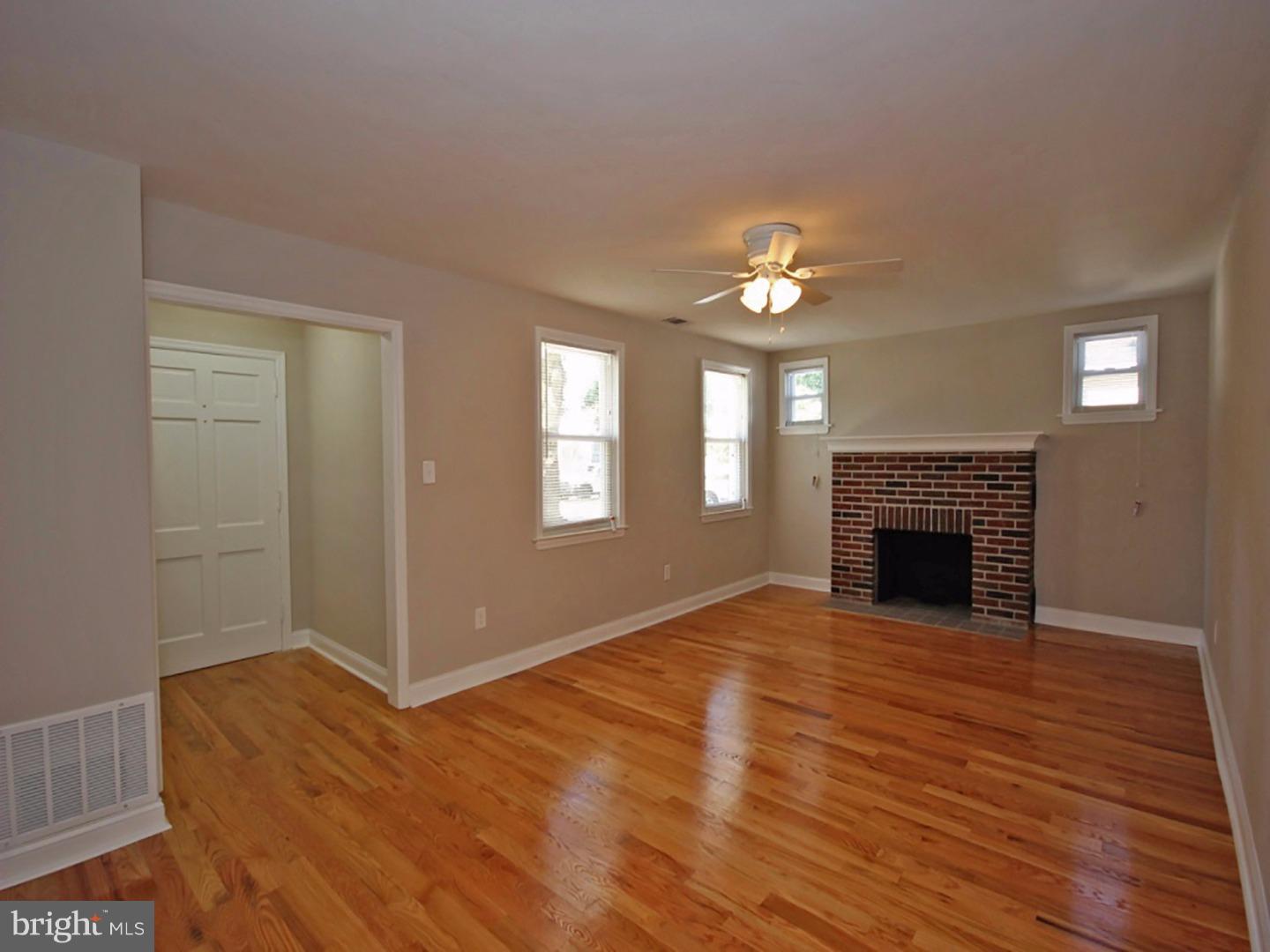 449 Pinecrest Road Springfield, PA 19064 - Photo 3 of 25 wooden floor fireplace and windows in an empty room