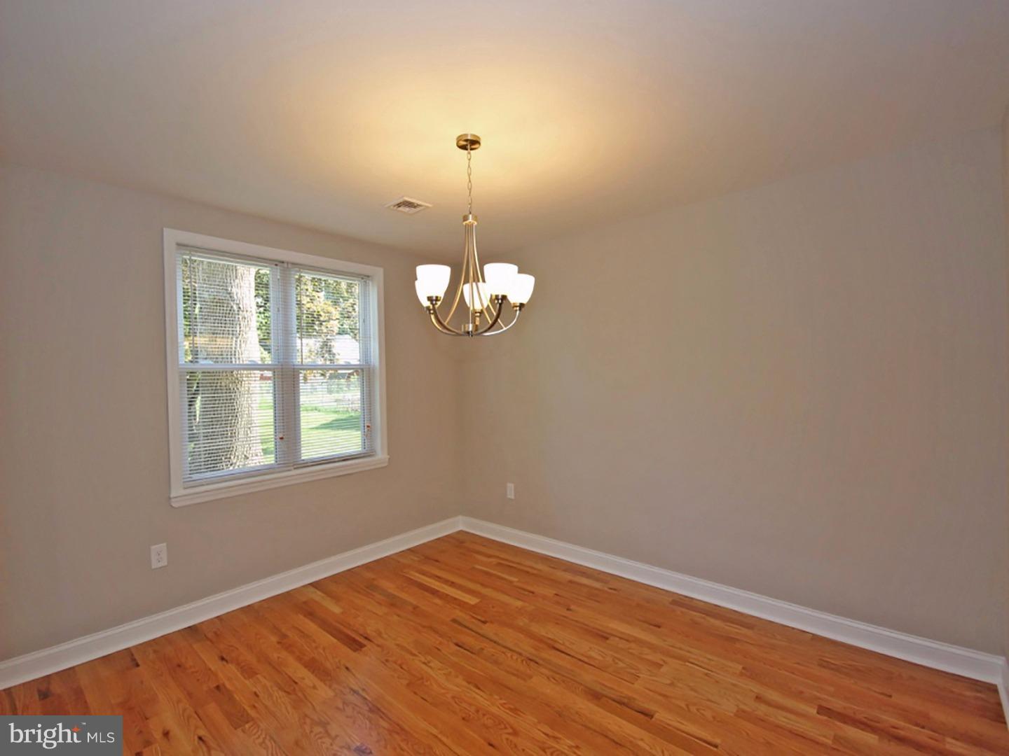449 Pinecrest Road Springfield, PA 19064 - Photo 5 of 25 an empty room with wooden floor and windows