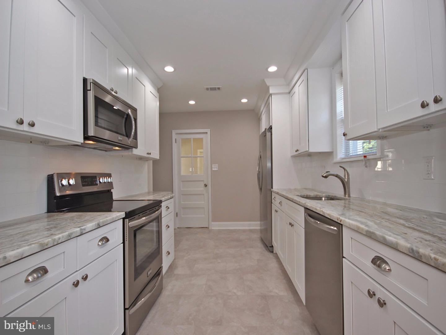449 Pinecrest Road Springfield, PA 19064 - Photo 8 of 25 a kitchen with granite countertop sink stainless steel appliances and cabinets