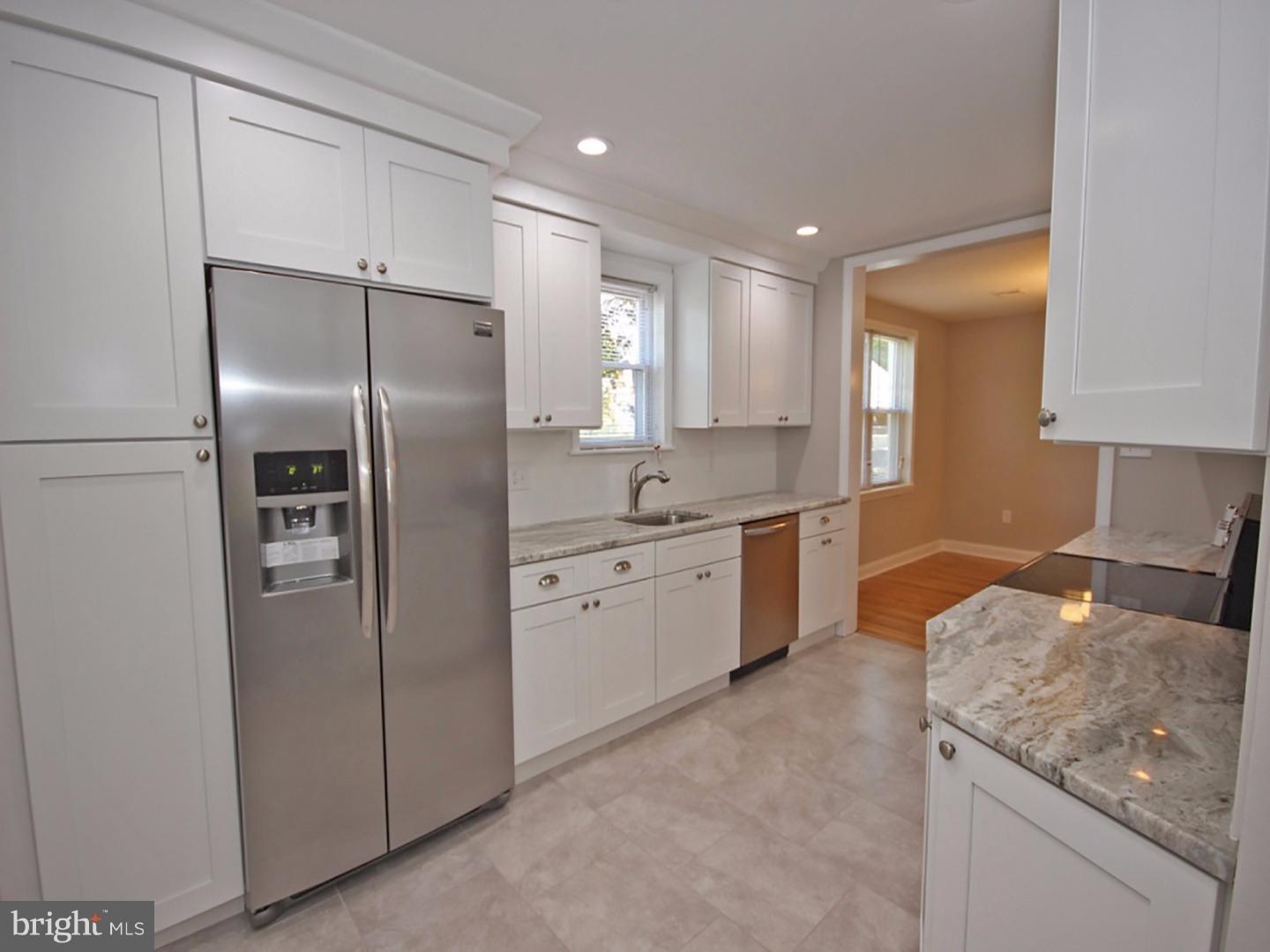449 Pinecrest Road Springfield, PA 19064 - Photo 9 of 25 a kitchen with a refrigerator sink and cabinets