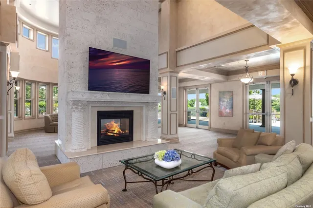 a living room with furniture a rug and a fireplace