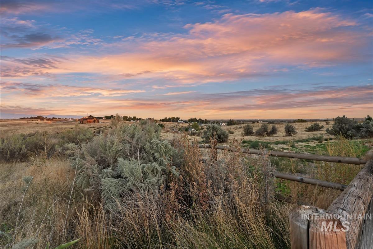 24398 Tombstone Ridge Court Middleton, ID 83644 - Photo 32 of 48 Expansive rural landscape featuring a rustic wooden fence and distant structures