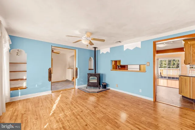 a view of a livingroom with wooden floor and a window