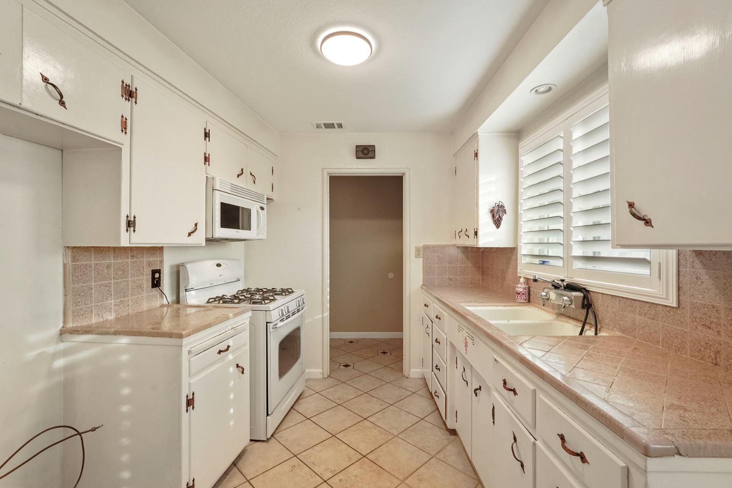 1007 Cardinal Street Lodi, CA 95240 - Photo 9 of 31 a bathroom with double vanity sink and mirror