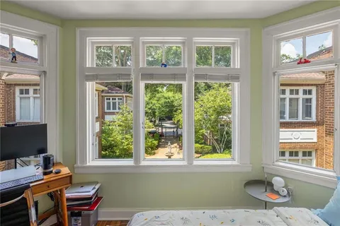 a living room with furniture and floor to ceiling windows