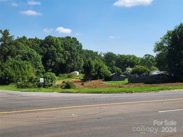 a view of street with houses and trees in the background