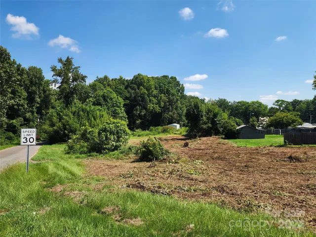 a view of a yard with yellow lighting
