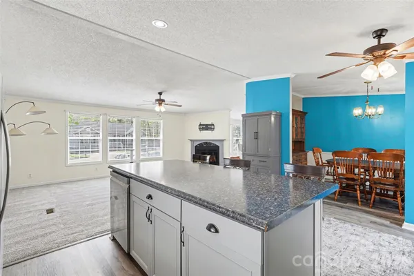 a view of a livingroom with furniture cabinet wooden floor and a rug