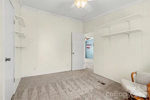 a living room with furniture a chandelier and a window