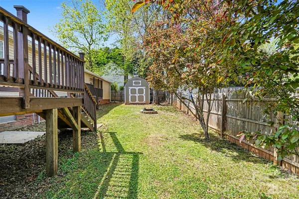 a view of backyard with a car parked in it